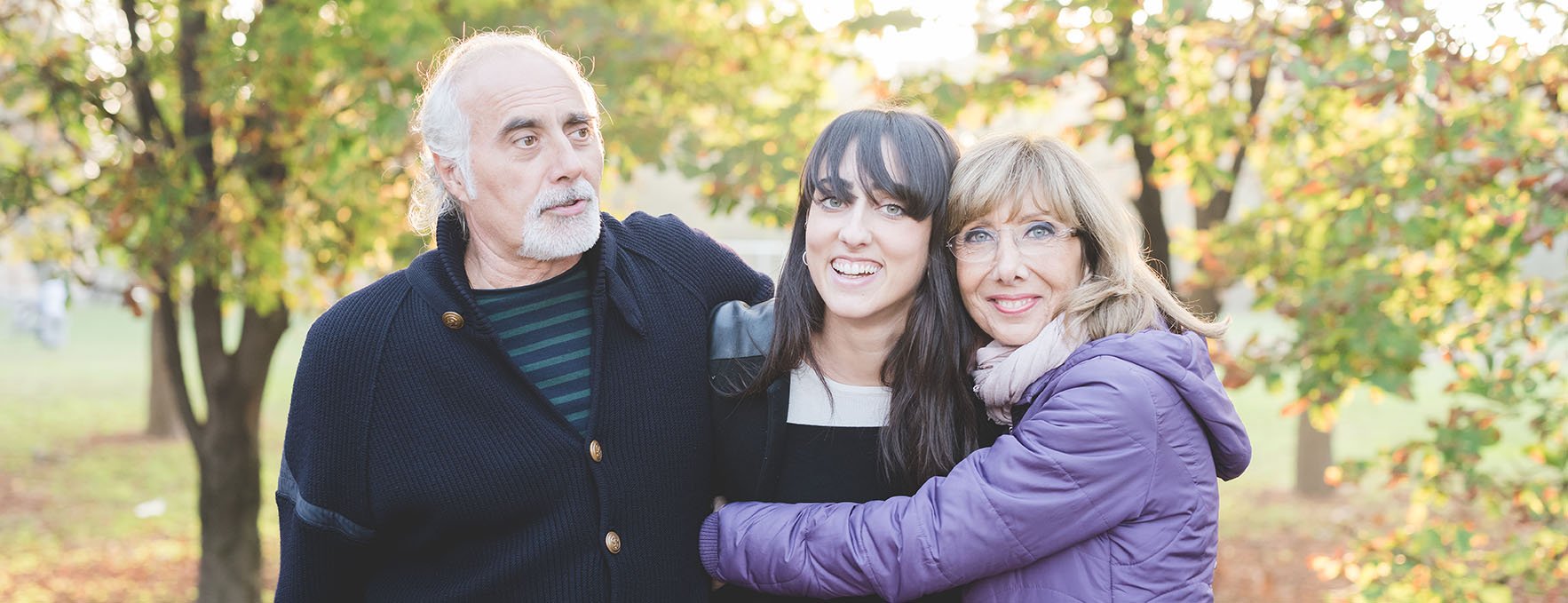 father-and-mother-hugging-daughter-2024-10-14-21-55-30-utc